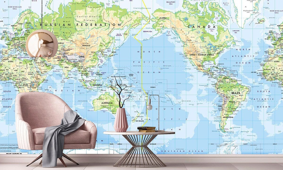 Vintage World Map Mural Wallpaper in a modern living room with a pink armchair and glass table.