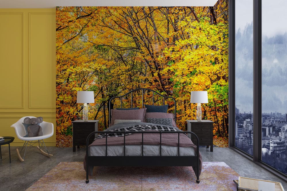 Autumn mural wallpaper with black bed, yellow wall, grey flooring, and modern grey chair in bedroom.