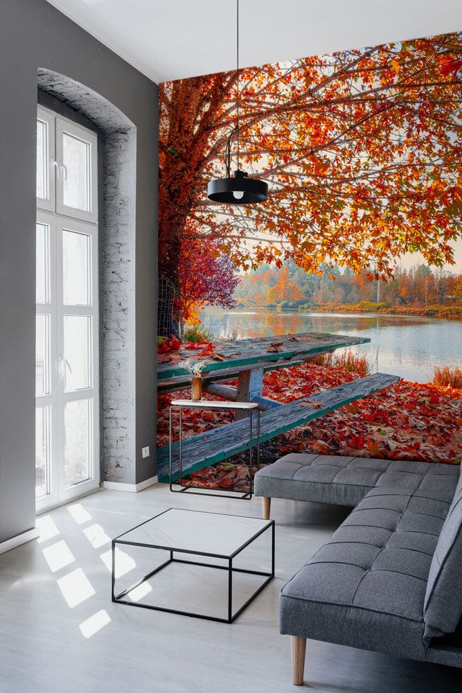 Vibrant autumn lake view mural wallpaper with grey sofa, white floor, modern minimalistic decor.