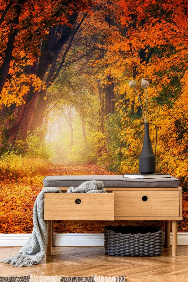 Autumn Forest Path Mural Wallpaper in warm colours, wooden bench, herringbone flooring, stylish vase.