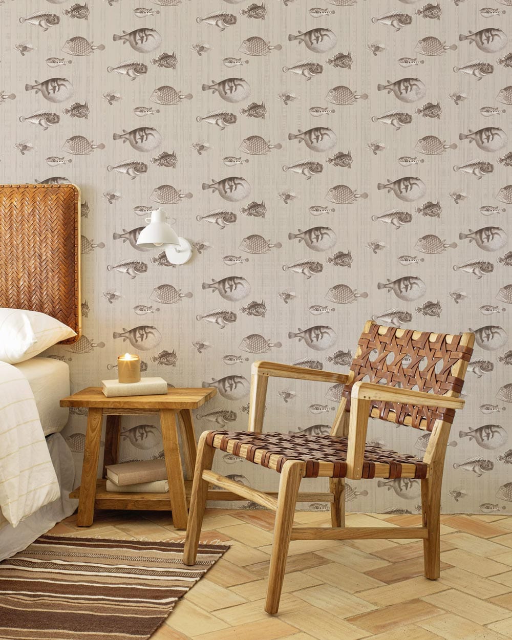 Vintage sepia nautical sketch wallpaper, cosy bedroom, woven chair, wooden flooring, bedside table, lamp.