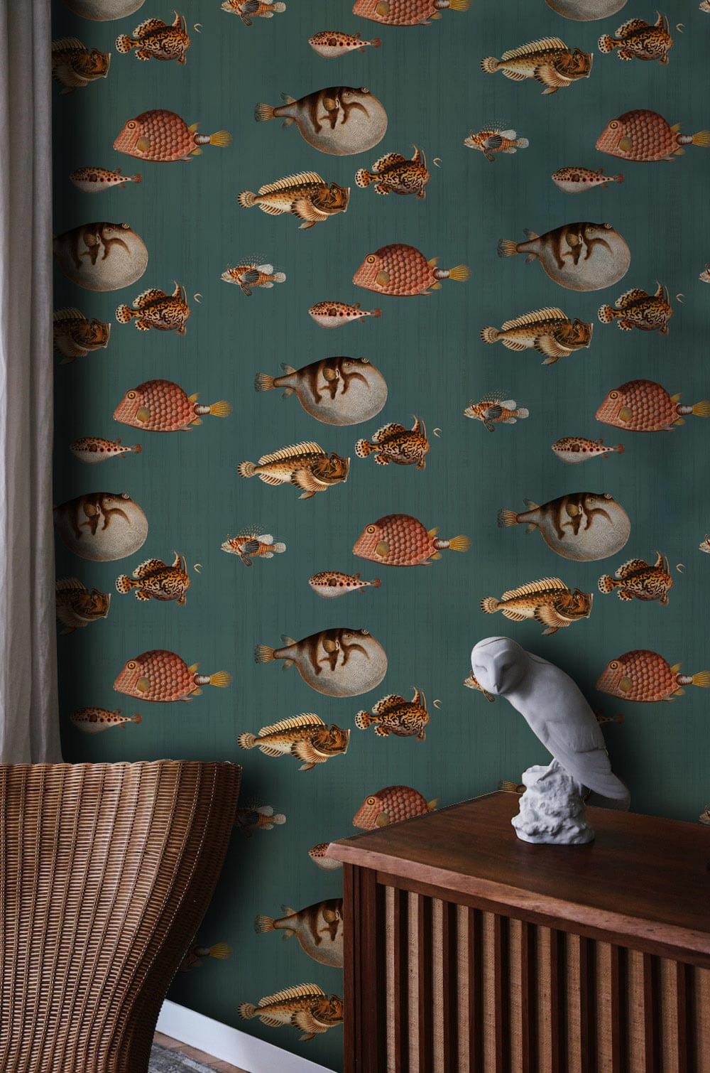 Teal and coral nautical-patterned wallpaper, wicker chair, wood cabinet, elegant room decor.