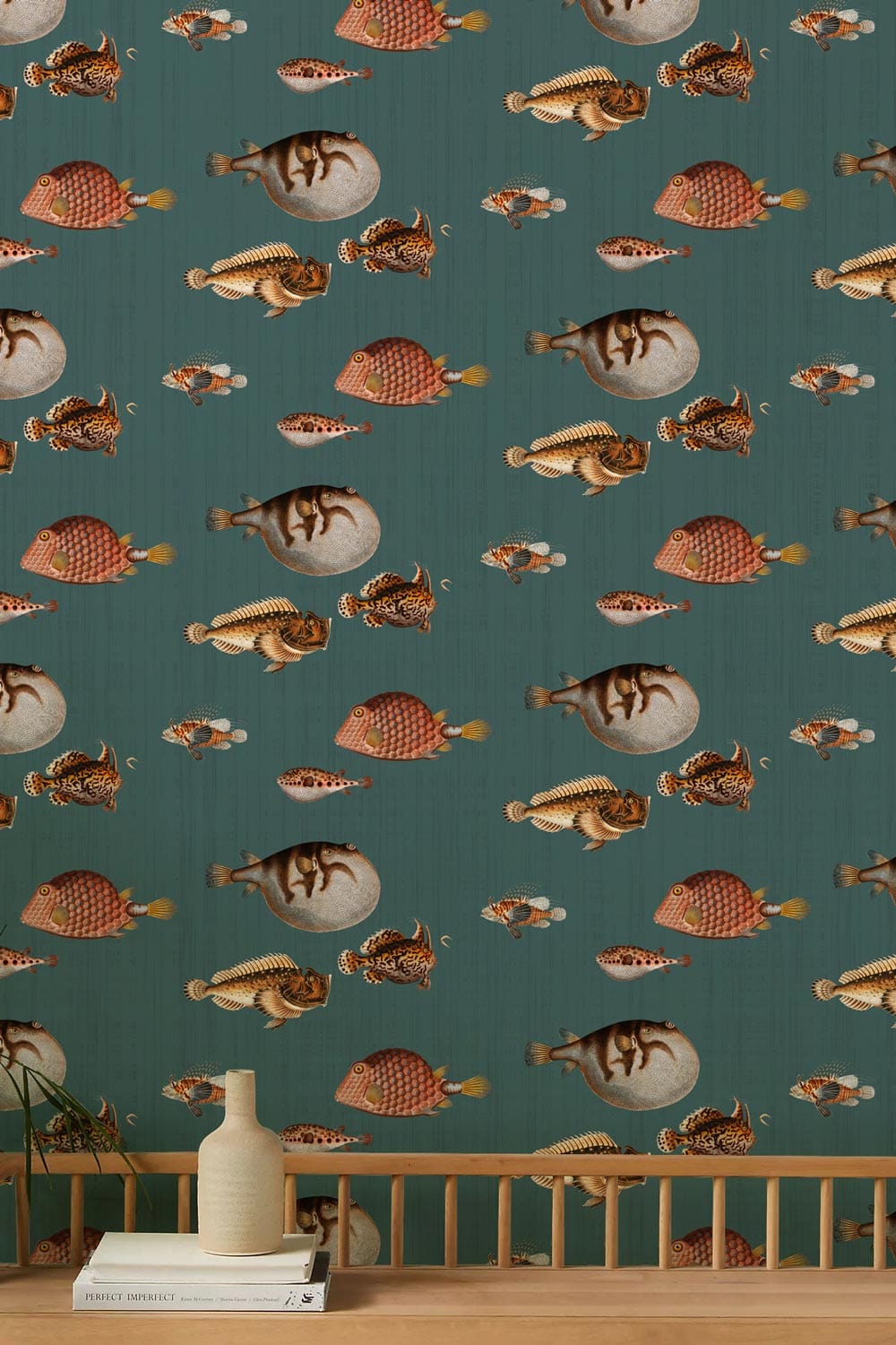 Vintage nautical wallpaper in teal and coral with fish pattern, wooden bench, light wood surface.