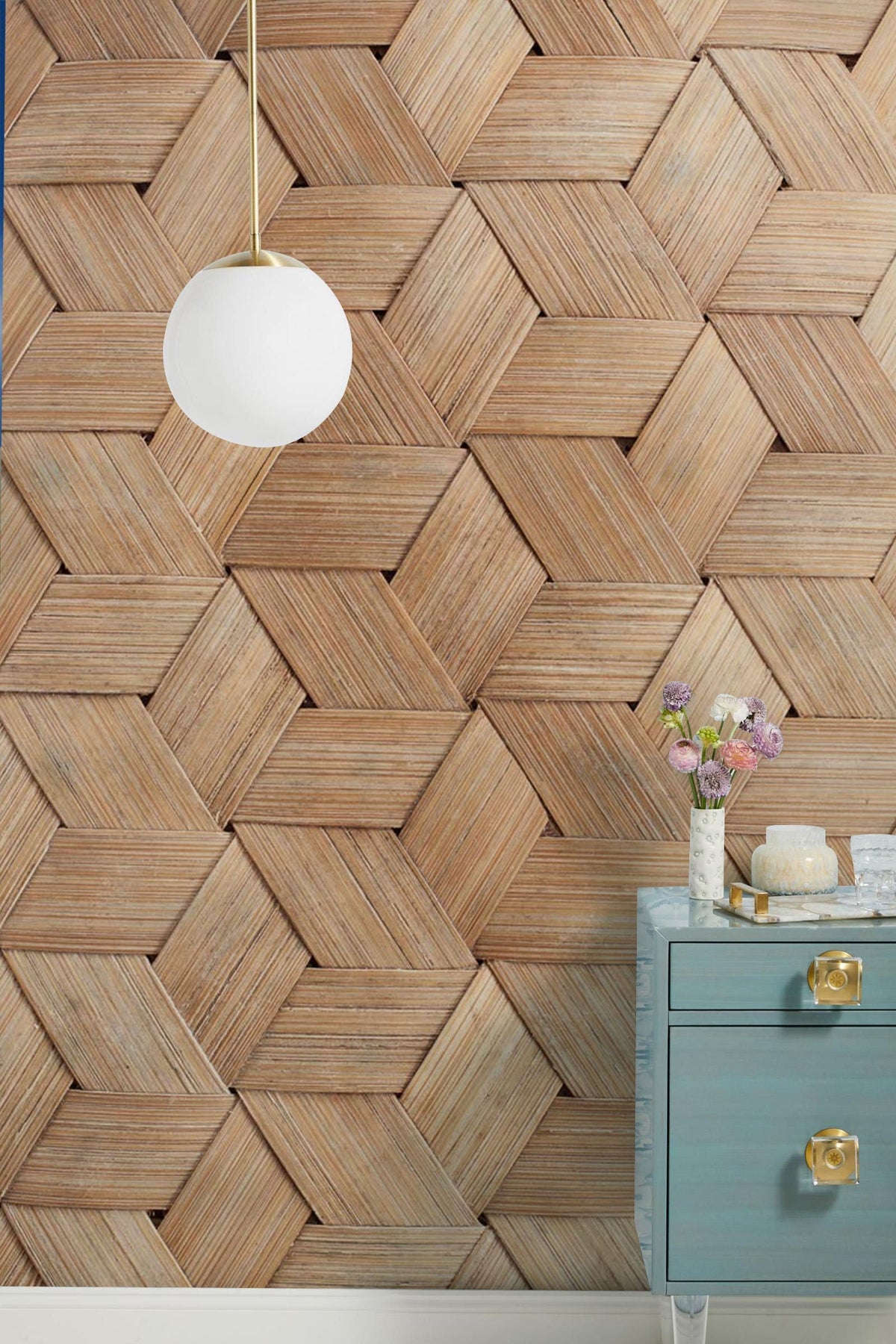 Geometric bamboo texture wallpaper, modern wood effect, blue drawer unit, globe pendant light in room.
