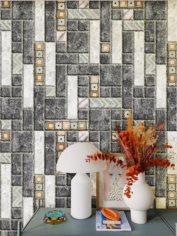 Grey stone and patterned brickwork mural wallpaper, industrial style, with modern lamp and neutral table.