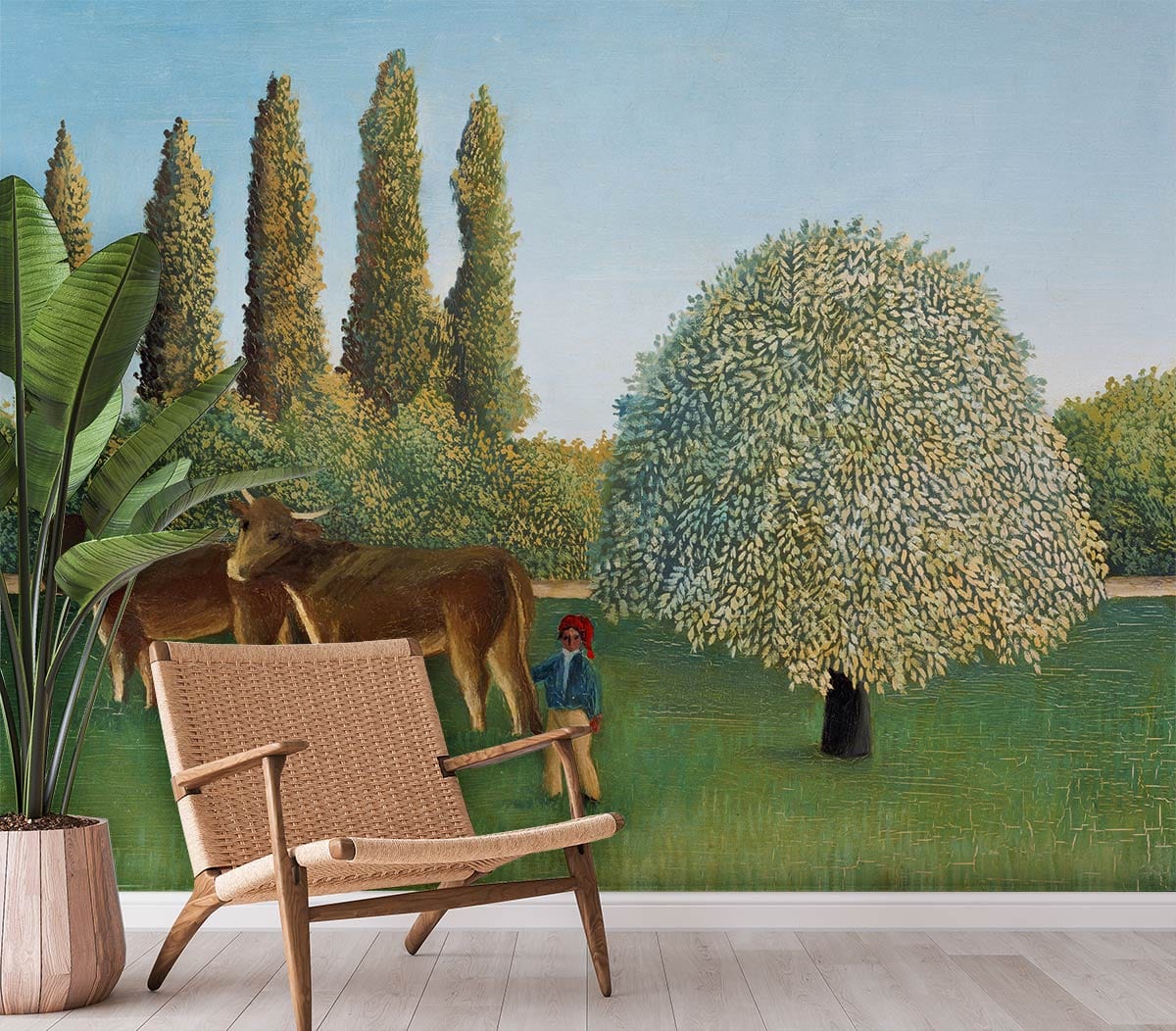 Peaceful countryside wallpaper with cows, wicker chair, wooden flooring; room features potted plant decor.