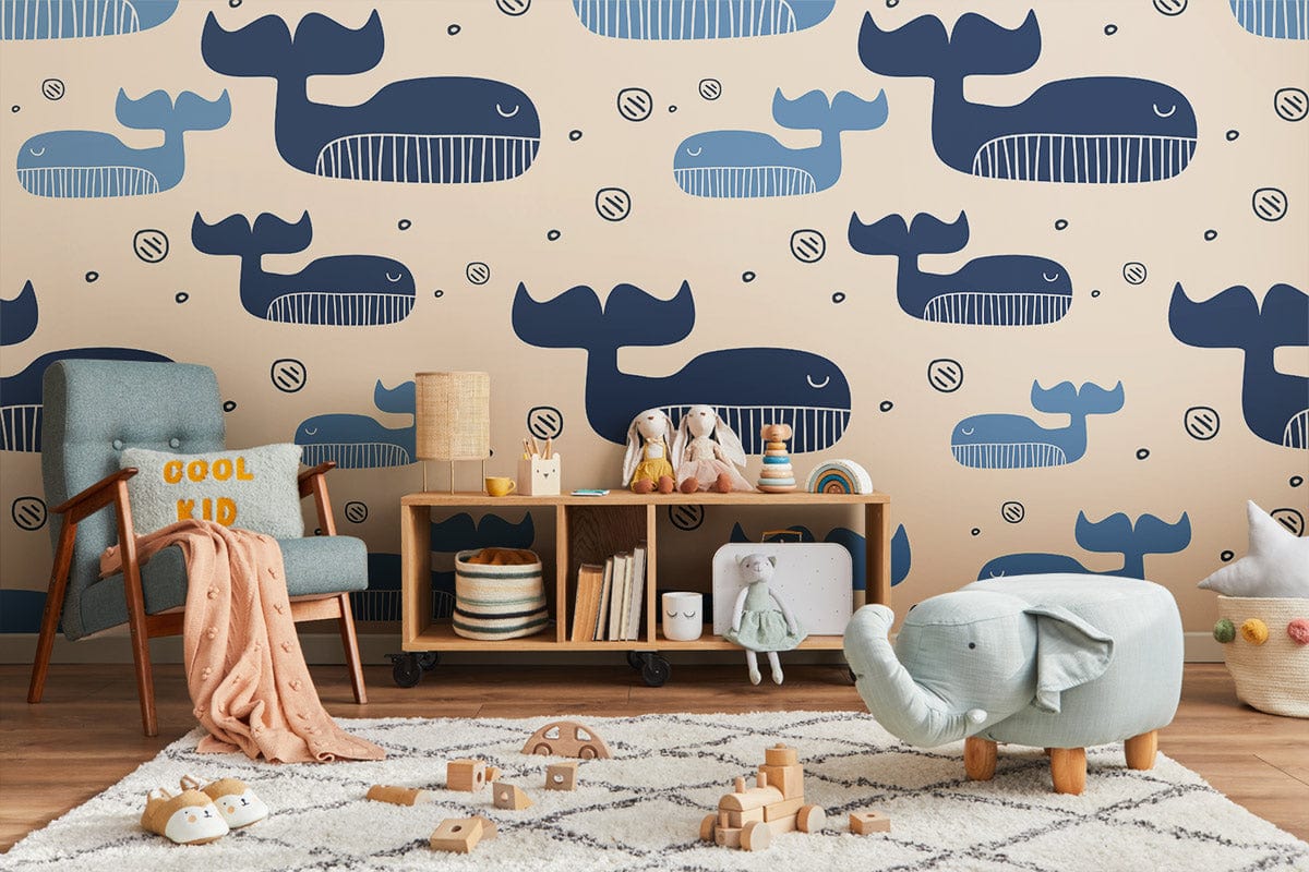 Children's room decor with blue whale wallpaper, beige walls, armchair, wooden flooring, and toys.