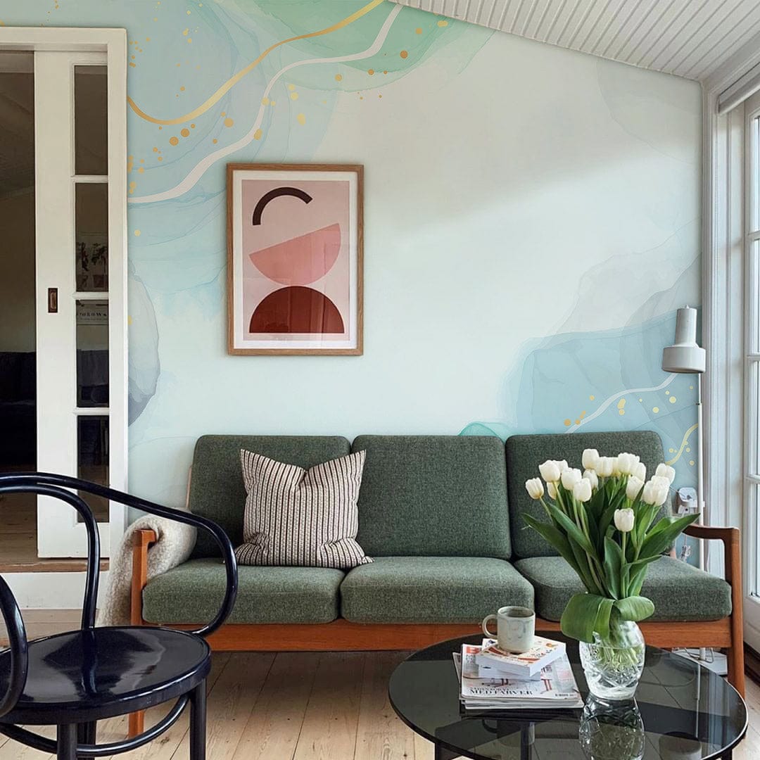Elegant Aqua Gold Watercolour Mural Wallpaper in modern living room with green sofa, art, and wood flooring.