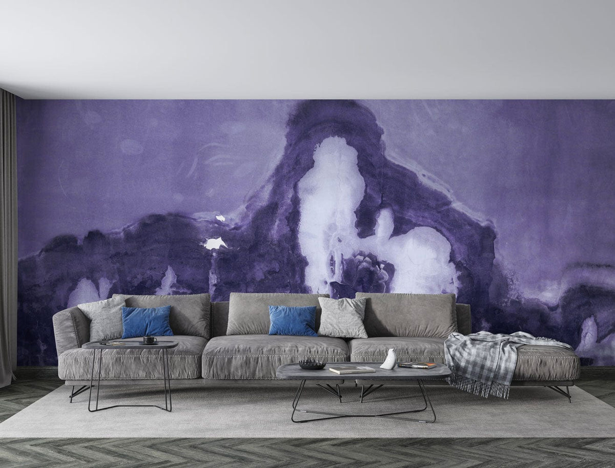 Modern living room with purple abstract wall mural, grey sofa, herringbone wood flooring, and minimalist tables.