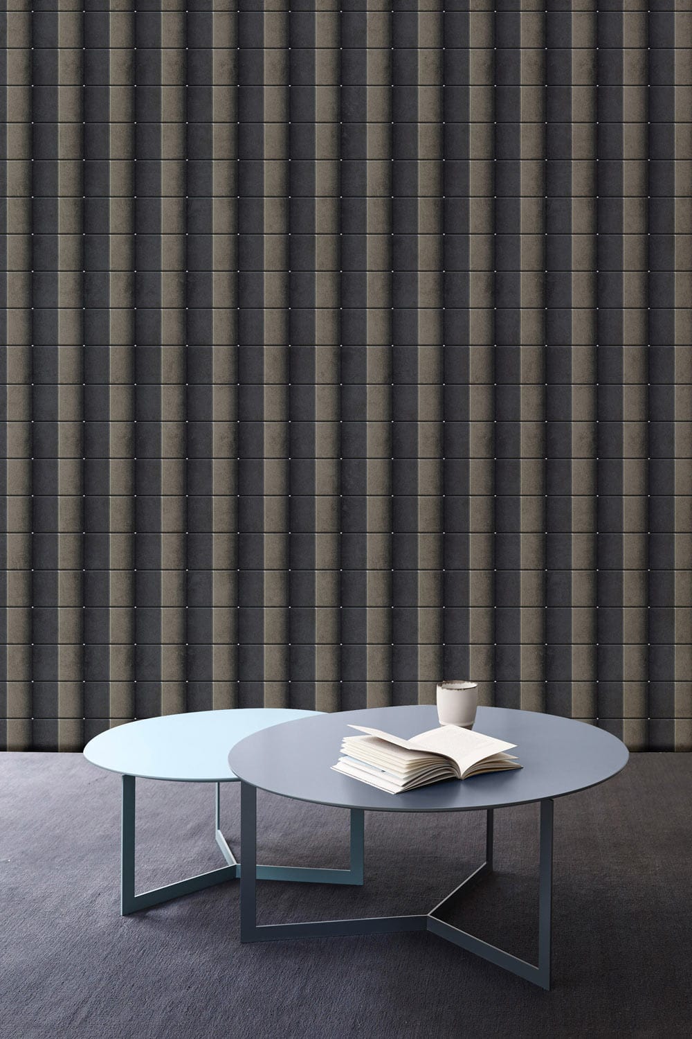 Modern Charcoal Vertical Stripe Wallpaper with blue tables, grey carpet in stylish interior design setting.