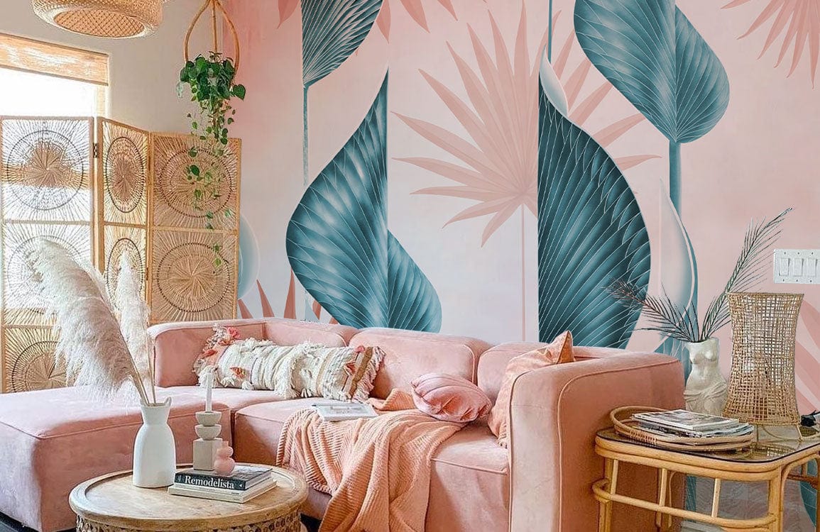 Tropical wallpaper with blue and coral leaves in a modern living room; pink sofa, wicker furniture.