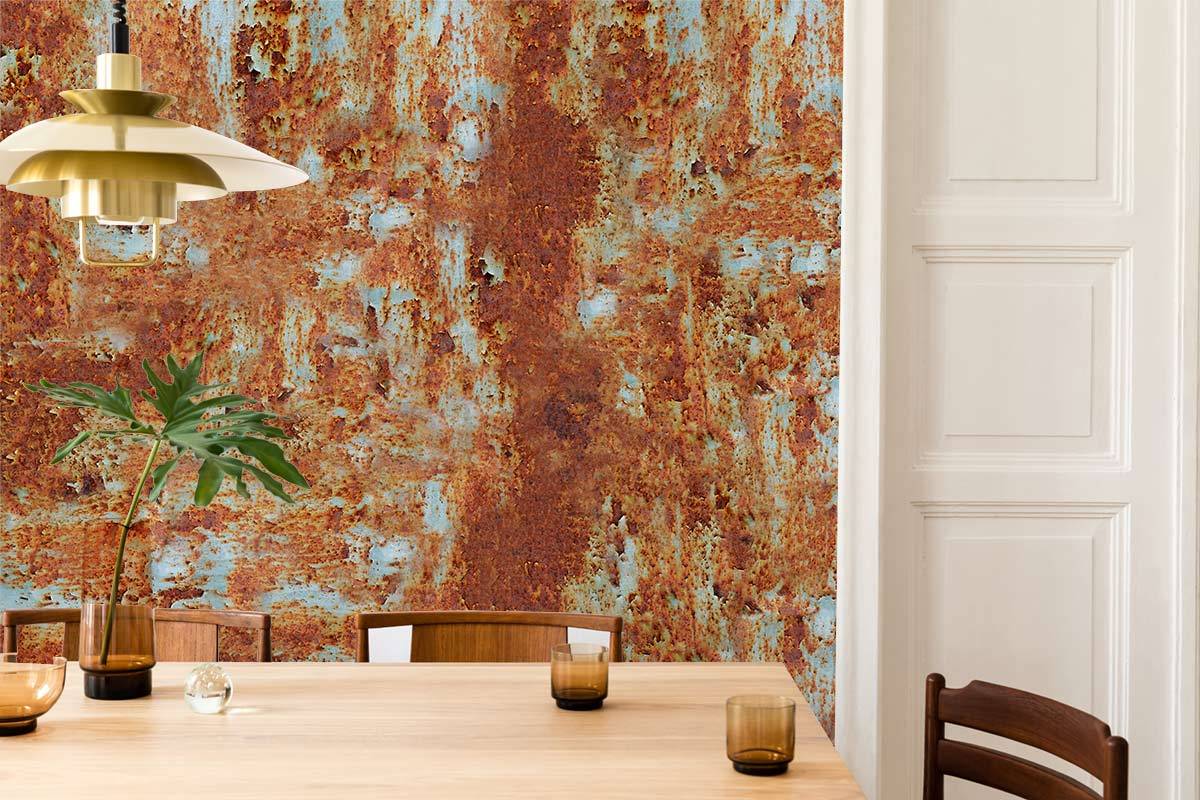 Earthy-tone vintage rust textured mural wallpaper in dining room with wooden table, pendant light, classic chair.