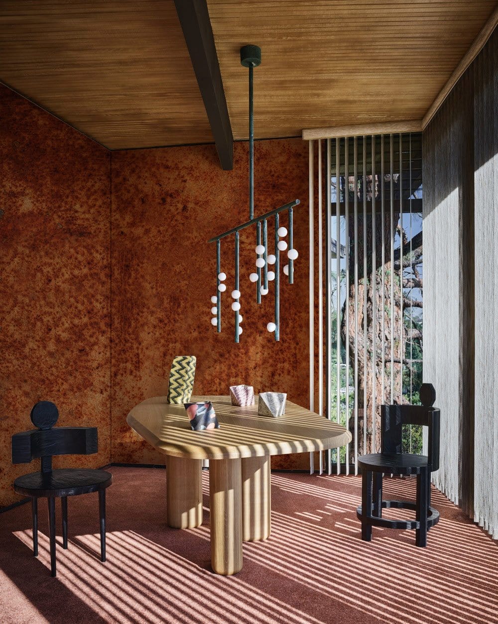 Vintage Rust Effect industrial wallpaper in dining room with modern wooden table, black chairs, pendant light.
