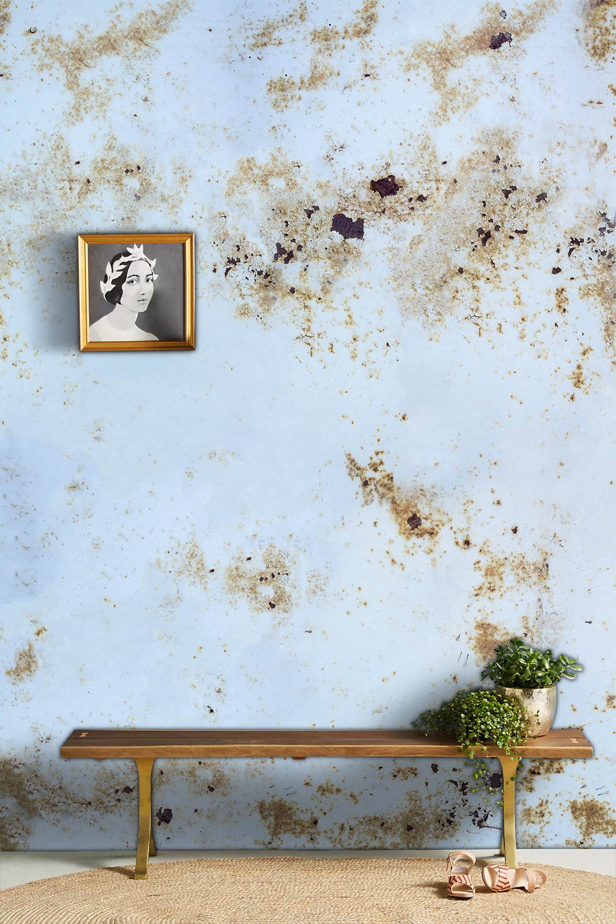 Vintage white and gold marble wallpaper, bench, rug, and portrait art in stylish contemporary setting.