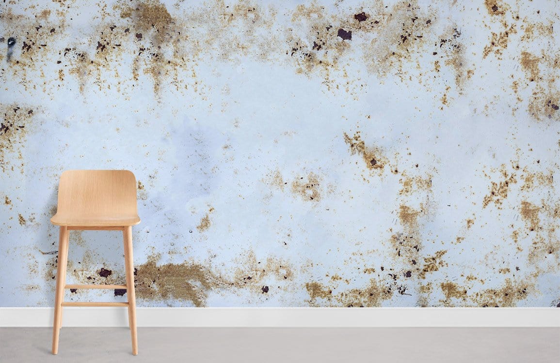Vintage distressed marble wallpaper with white and gold effect, light wood chair, grey floor.