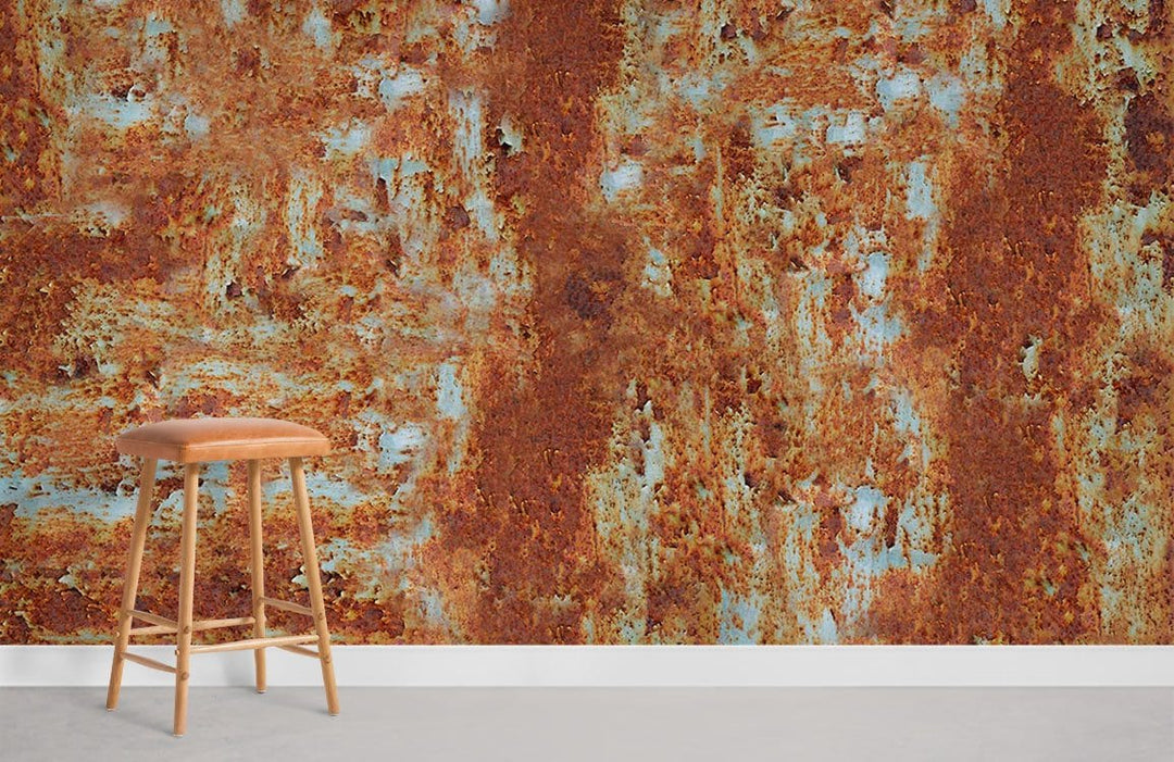 Vintage rust textured mural wallpaper with earthy tones; industrial style; wooden stool; grey flooring.