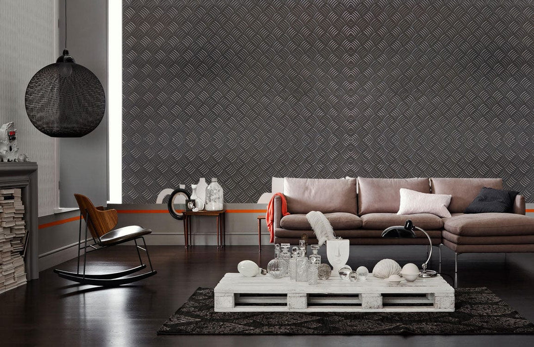 Industrial chic grey wallpaper, modern living room, brown sofa, dark wood flooring, textured wall design.