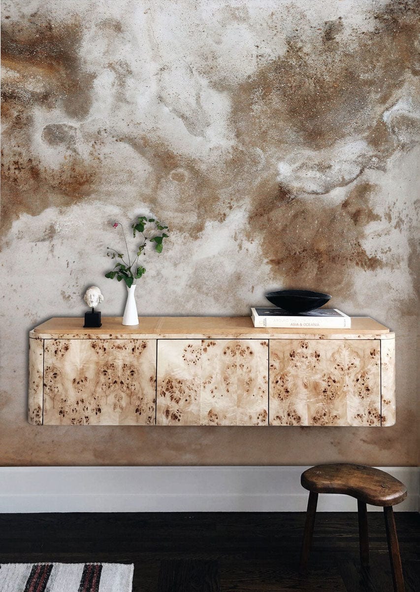 Earthy Textured Abstract Mural Wallpaper with rustic sideboard, wooden stool, dark wood flooring.