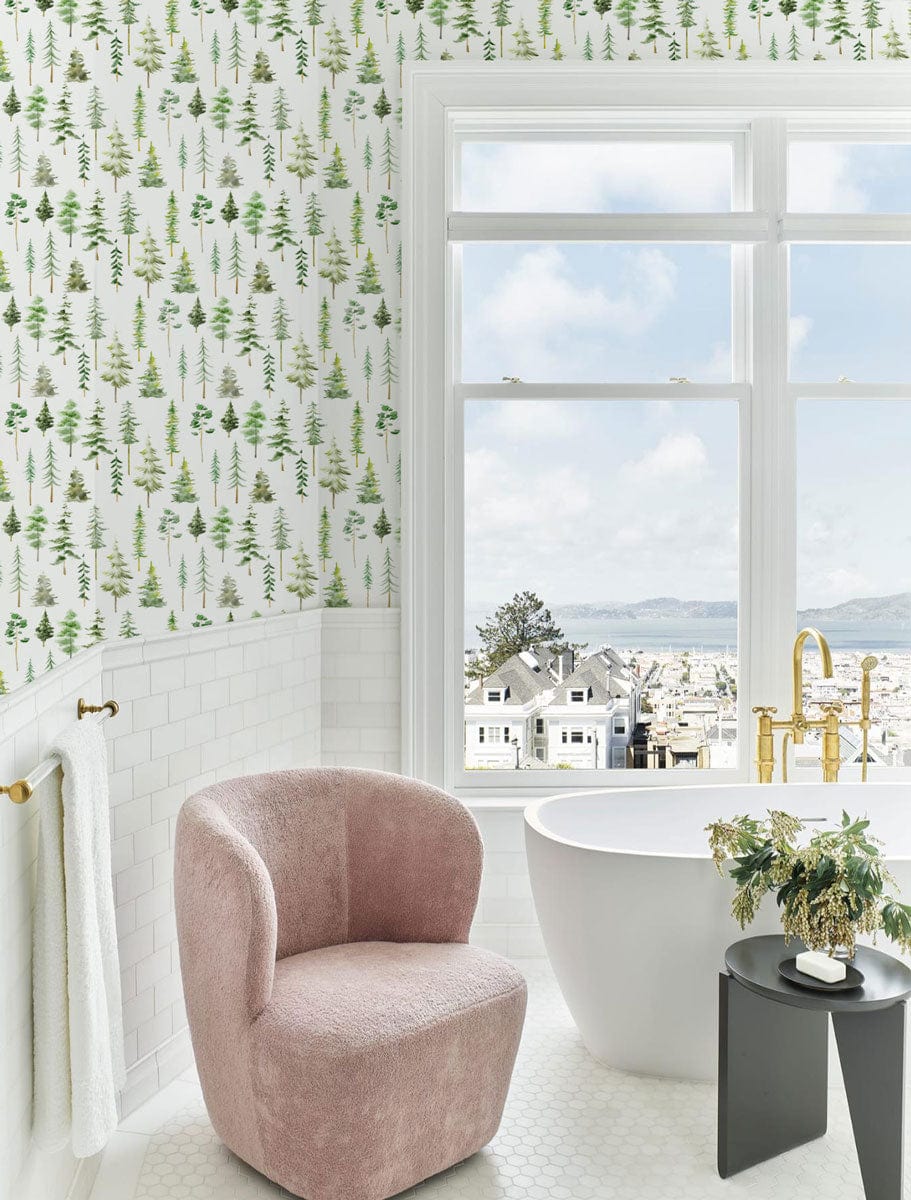 Tranquil Green Forest wallpaper, modern bathroom with pink chair, white bathtub, gold fixtures, city view.