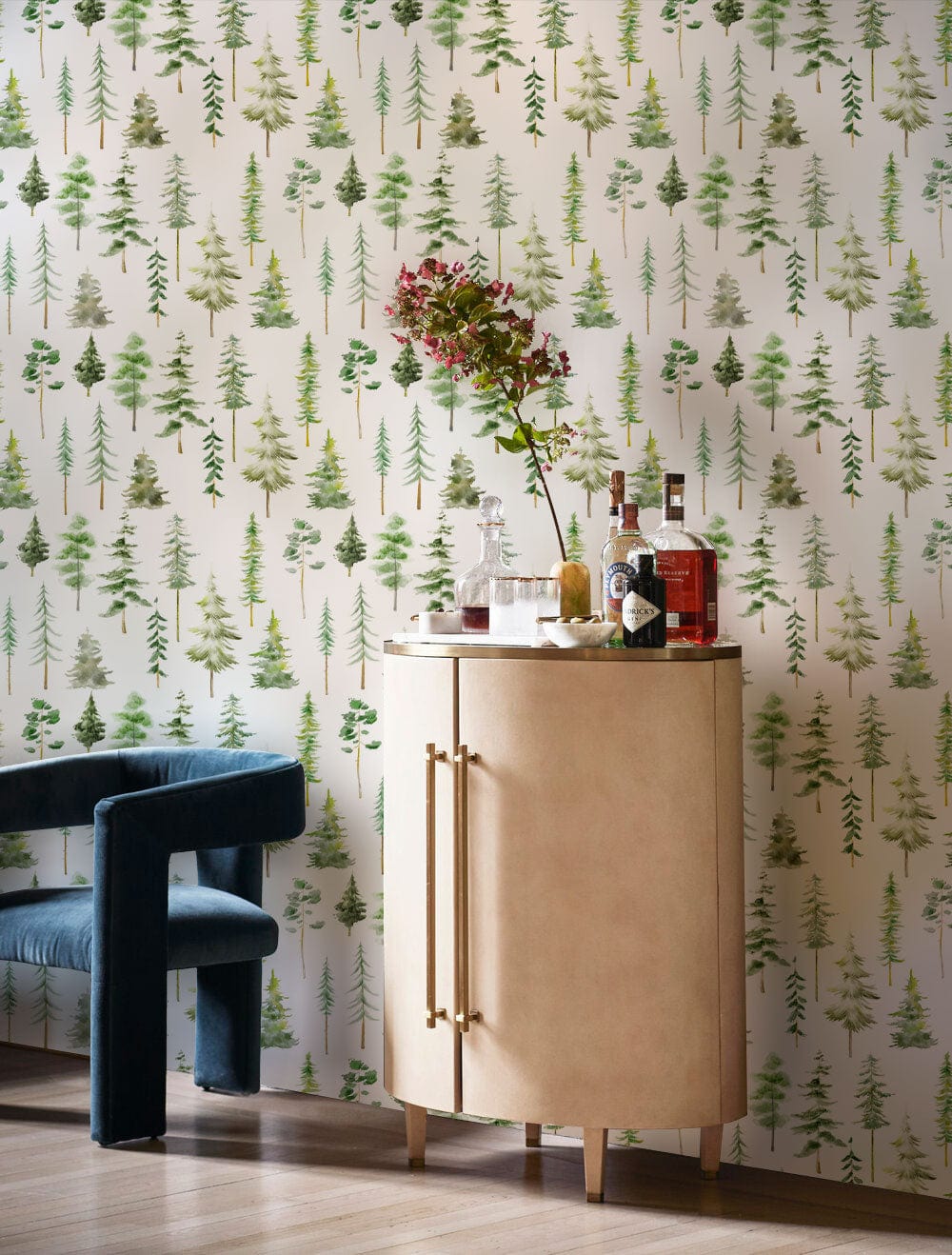 Tranquil Green Forest wallpaper complements modern interiors with blue velvet chair and wooden flooring.