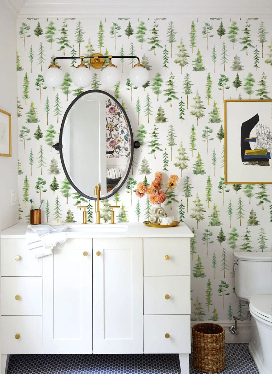 Tranquil Green Forest wallpaper in modern bathroom with white vanity, brass fixtures, and wall art.