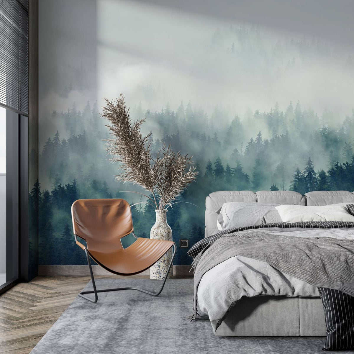Misty Forest Green Scenic Mural Wallpaper in bedroom with grey bed, leather chair, wooden flooring.