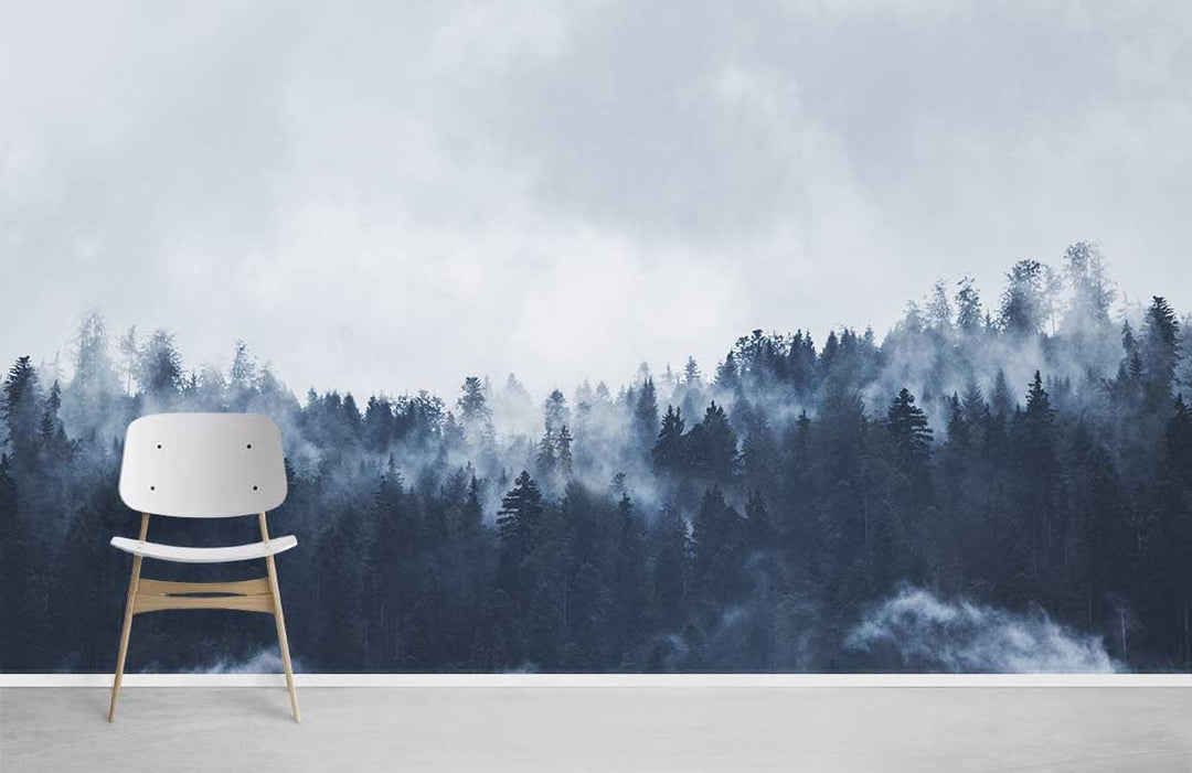 Modern chair against Enchanted Misty Forest Mural Wallpaper, serene blue-grey nature landscape art backdrop.
