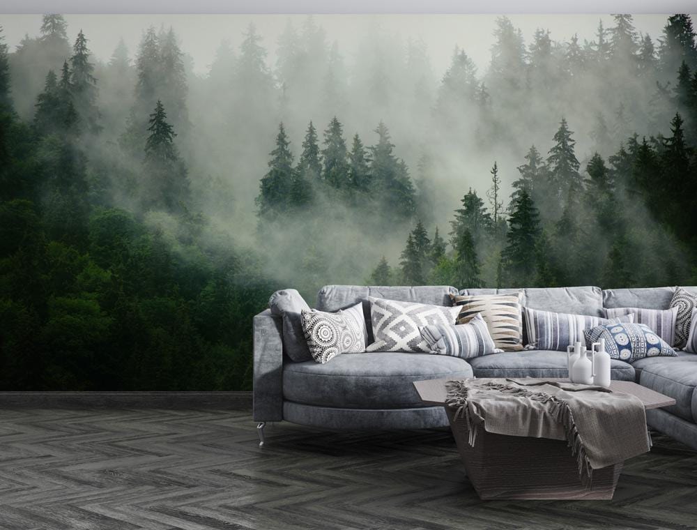Mystical forest mural wallpaper, grey sectional sofa, herringbone flooring in modern living room setting.