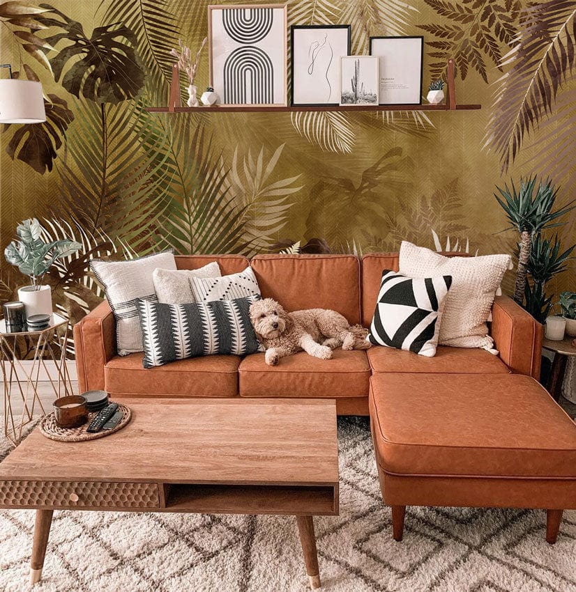 Vintage Tropical Foliage Wallpaper in earthy browns, with tan sofa, wooden coffee table, living room.