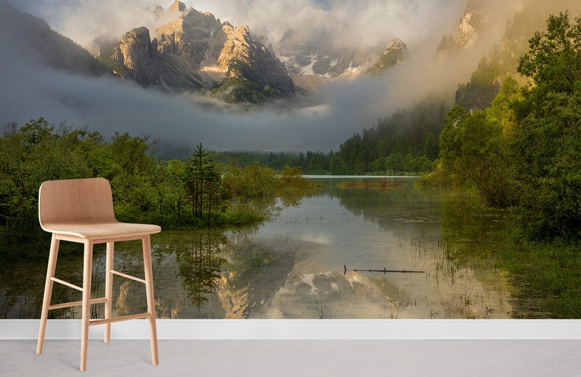 Misty Mountain Landscape Mural Wallpaper with serene green tones, light wood chair, in contemporary room.