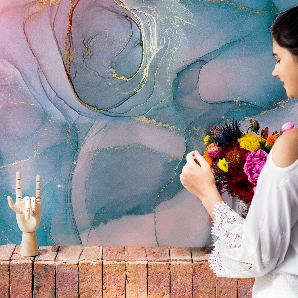 Elegant abstract marble mural wallpaper with blue, pink tones; brick sideboard; decorative wooden hand.