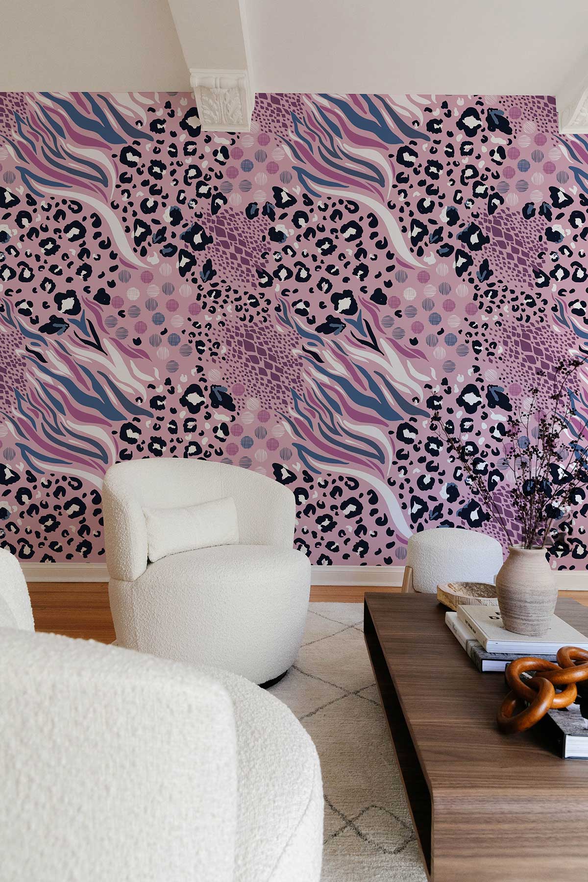 Abstract pink leopard print wallpaper in modern living room with white chairs and wooden table.