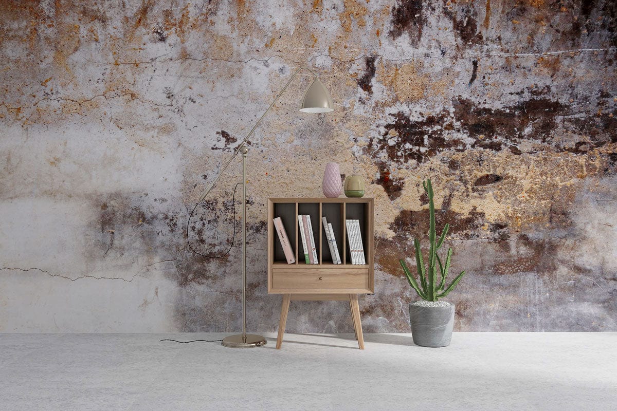 Vintage Urban Decay mural wallpaper, earthy tones, wooden bookshelf, potted plant, modern floor lamp.