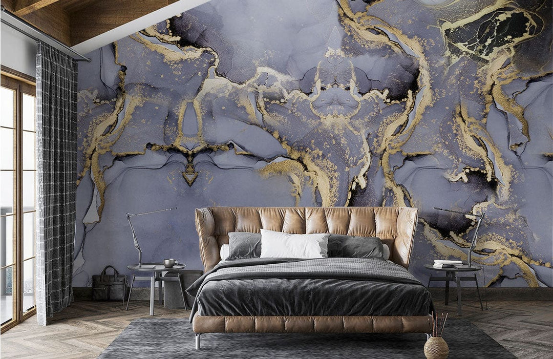 Luxurious grey-gold abstract mural wallpaper with brown tufted bed, grey bedding, hardwood flooring in bedroom.
