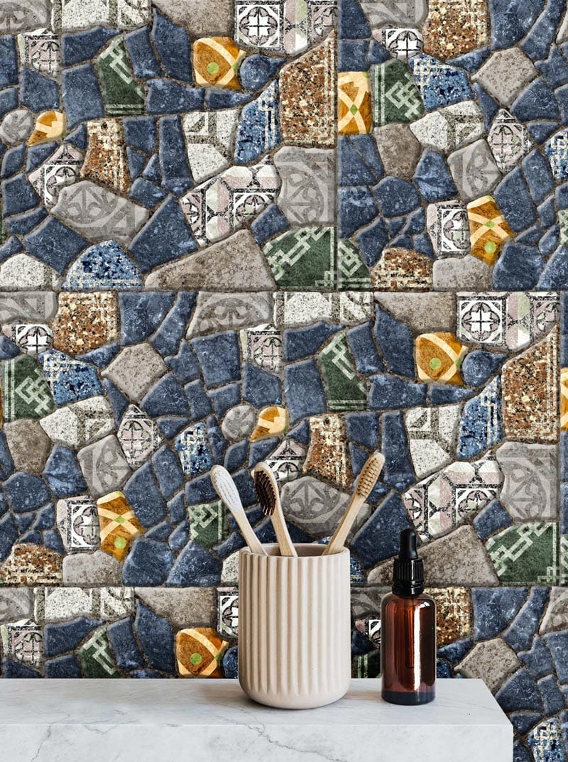 Colourful mosaic stone tile effect wallpaper with toothbrush holder and bottle on marble countertop.