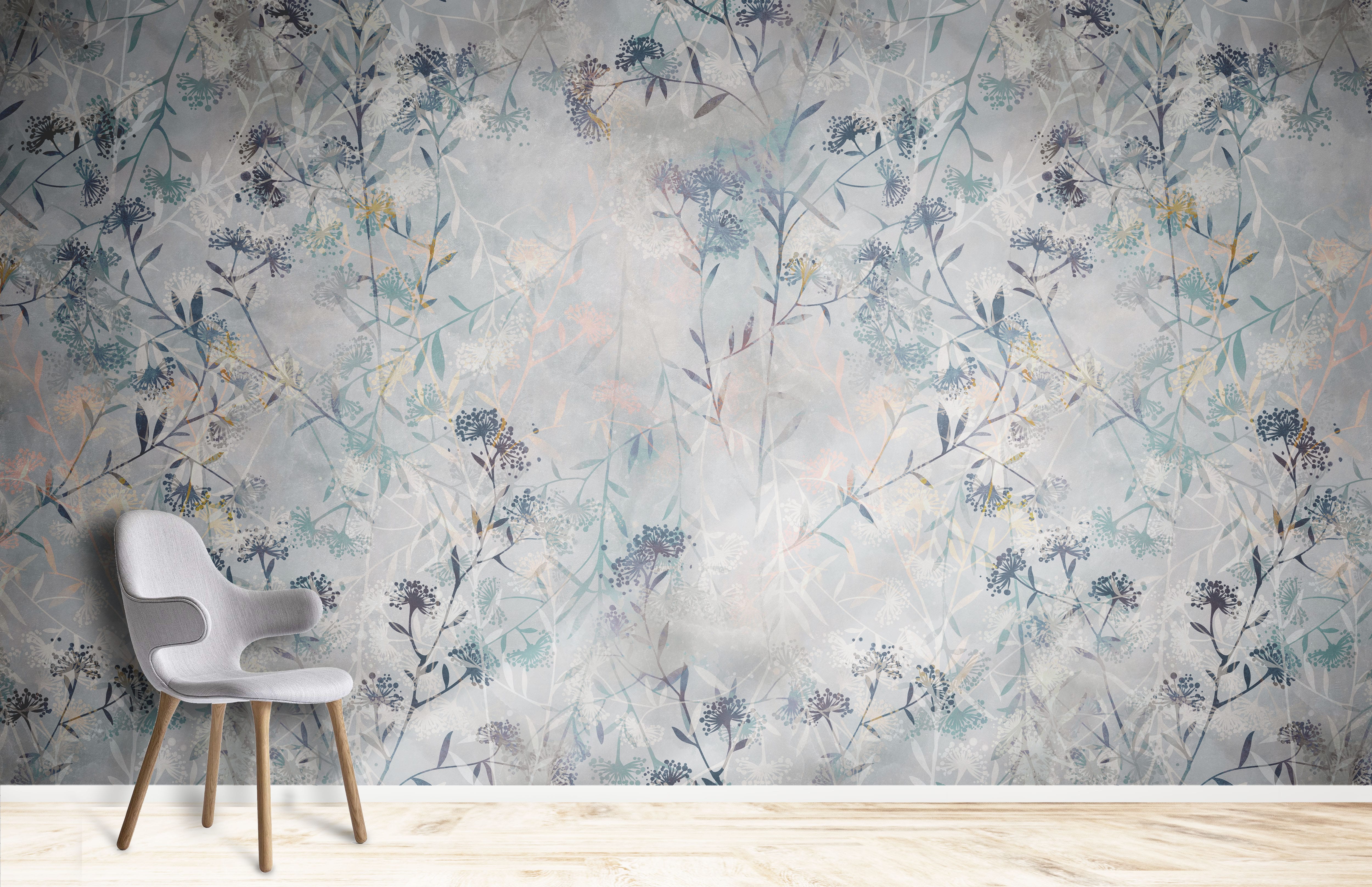 Serene Pastel Botanical Mural Wallpaper, subtle floral design, grey chair, light wood flooring, living room.