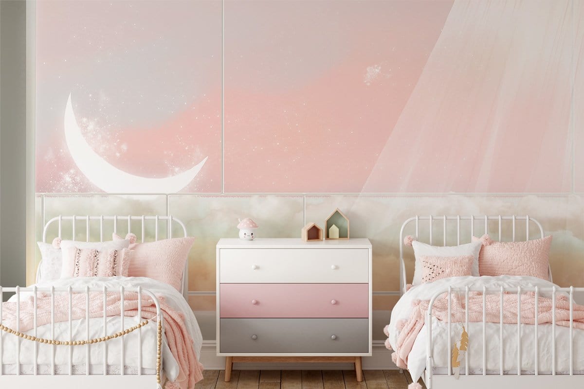Celestial Dreamscape pastel mural with crescent moon, white beds, pink bedding, wooden flooring, nursery decor.