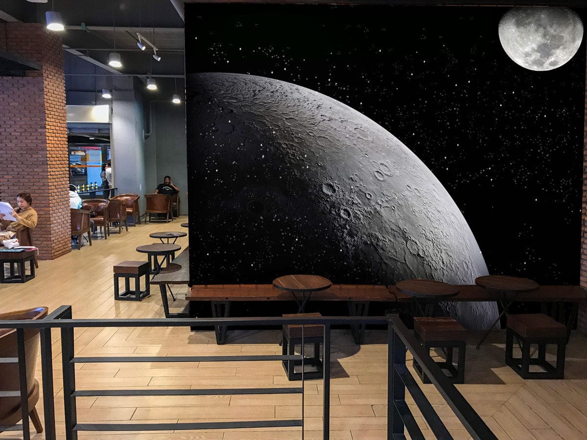 Lunar Landscape Mural Wallpaper in Monochrome, featuring moon design, displayed in modern cafe with wooden flooring.
