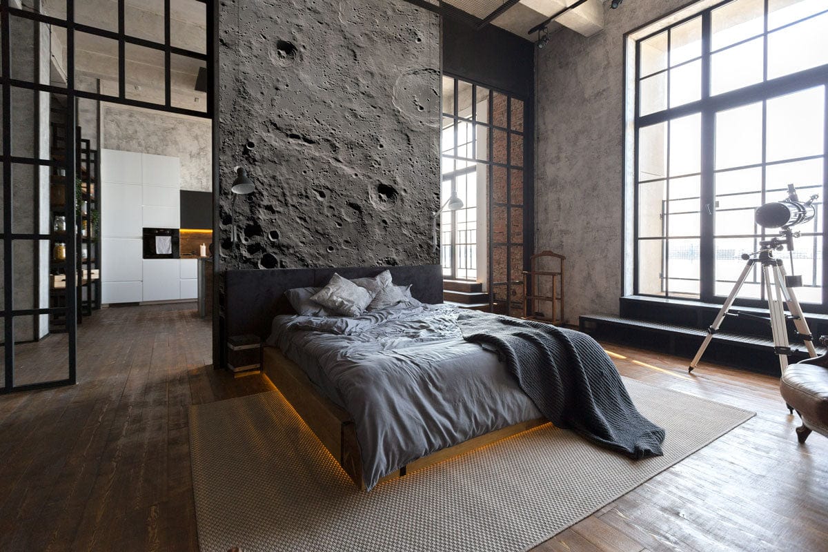 Textured moon mural wallpaper in bedroom with grey bedding, wood flooring, black metal windows, telescope.