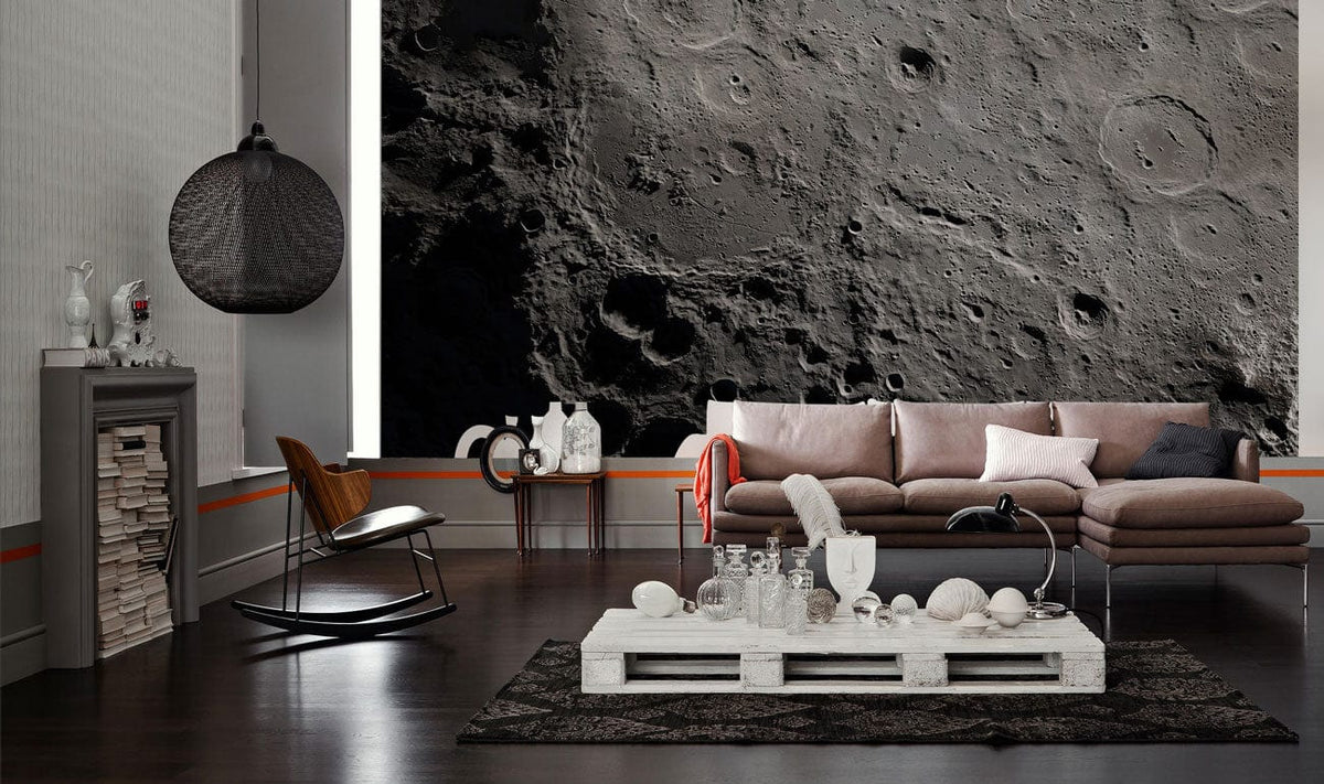 Textured grey moon mural wallpaper in living room with brown sofa, dark wood flooring, modern decor.