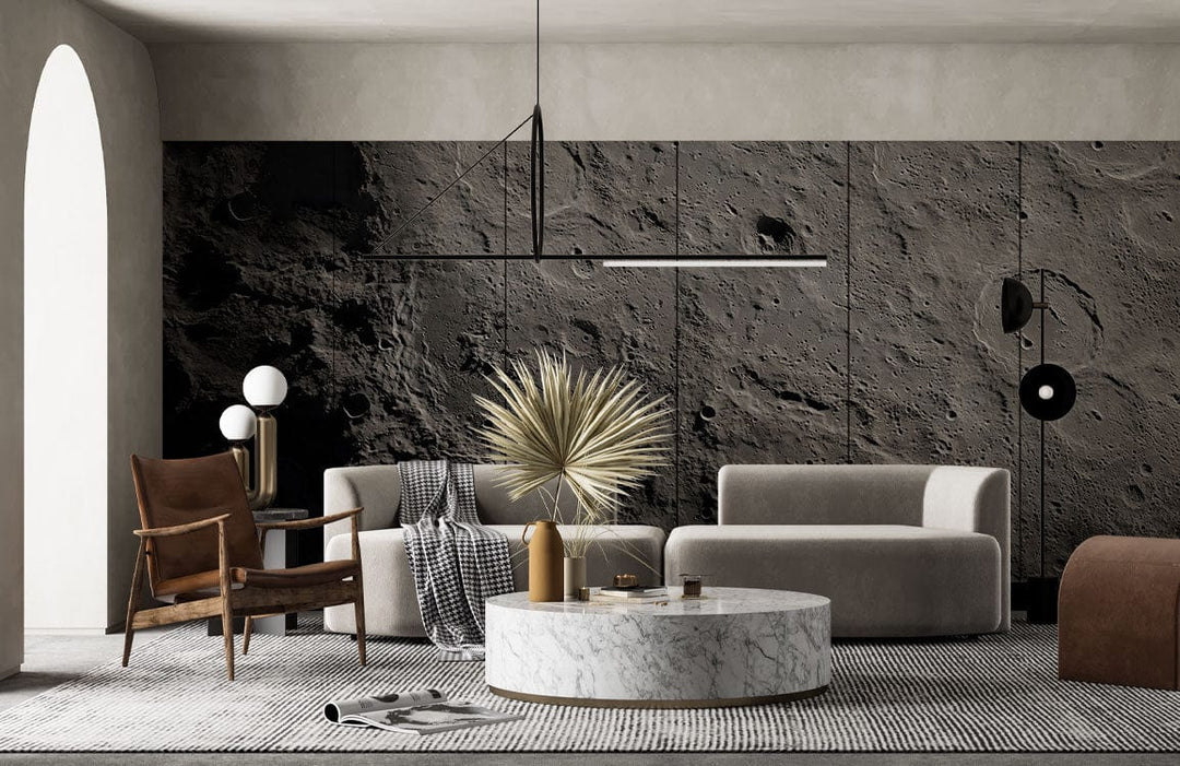 Textured Grey Moon Surface Mural Wallpaper in modern lounge with beige sofa, dark armchair, round marble table.