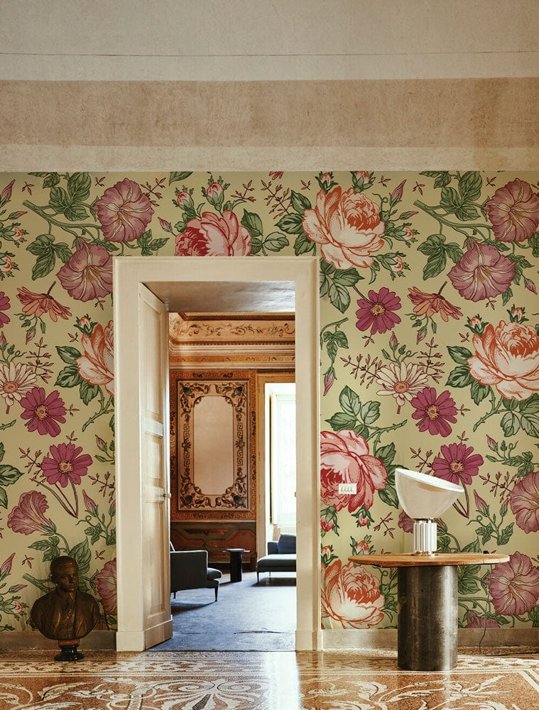 Vintage floral wallpaper with roses in pastel hues, wooden door, patterned flooring, classic interior setting.
