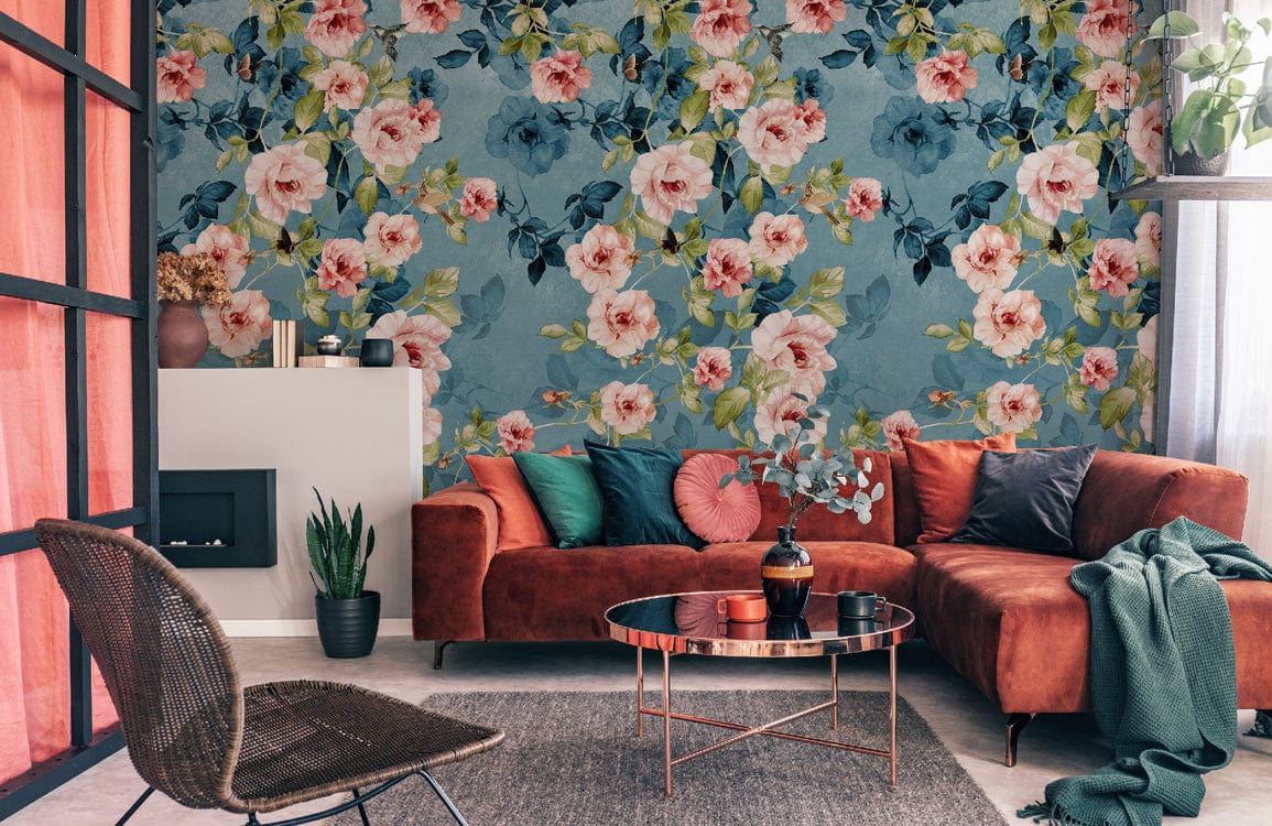 Vintage floral wallpaper with blue-pink roses, rust sofa, glass table, grey rug in elegant living room.