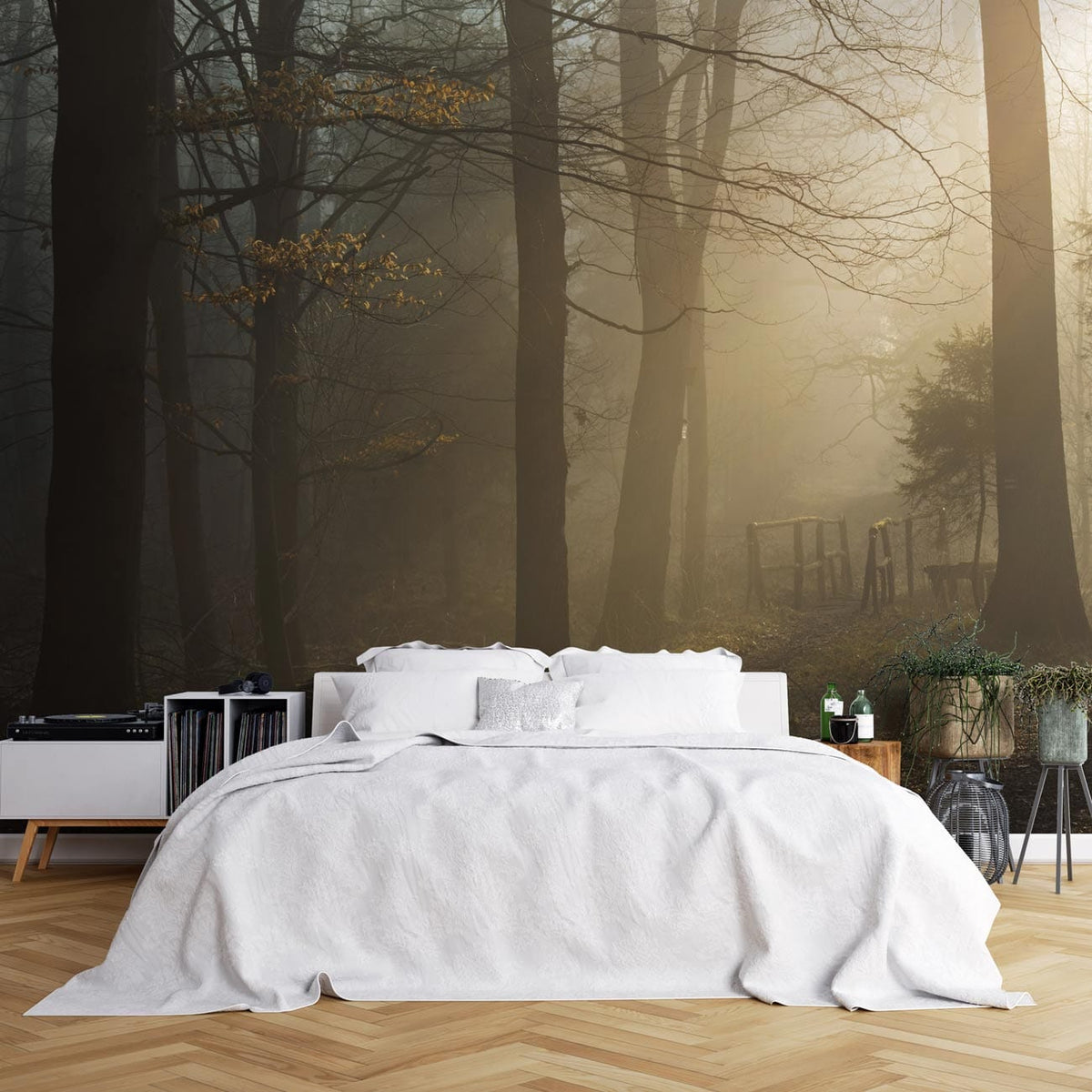 Mystical woodland mural wallpaper in bedroom with white bed, wooden floor, foggy forest scene backdrop.