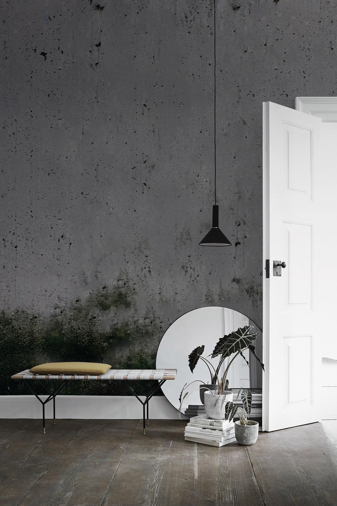 Urban Chic Grey Industrial Mural Wallpaper with modern bench, pendant light, and wooden flooring.