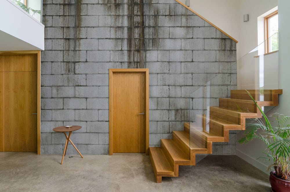 Industrial Grey Concrete Brick Wallpaper in urban loft with wooden stairs, concrete flooring, interior decor.