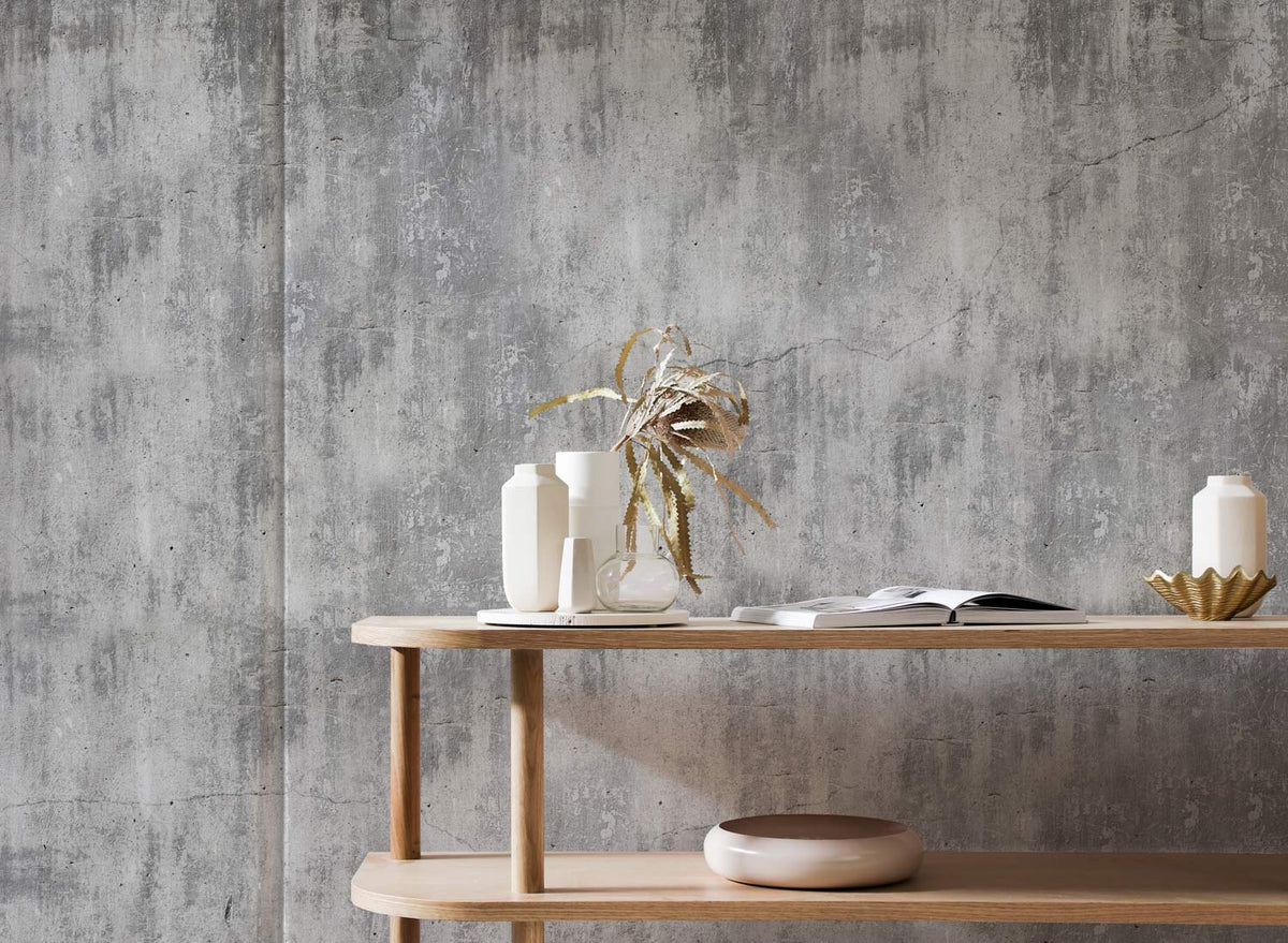 Industrial Chic wallpaper in modern living room, grey textured look, light wood console table, vases.