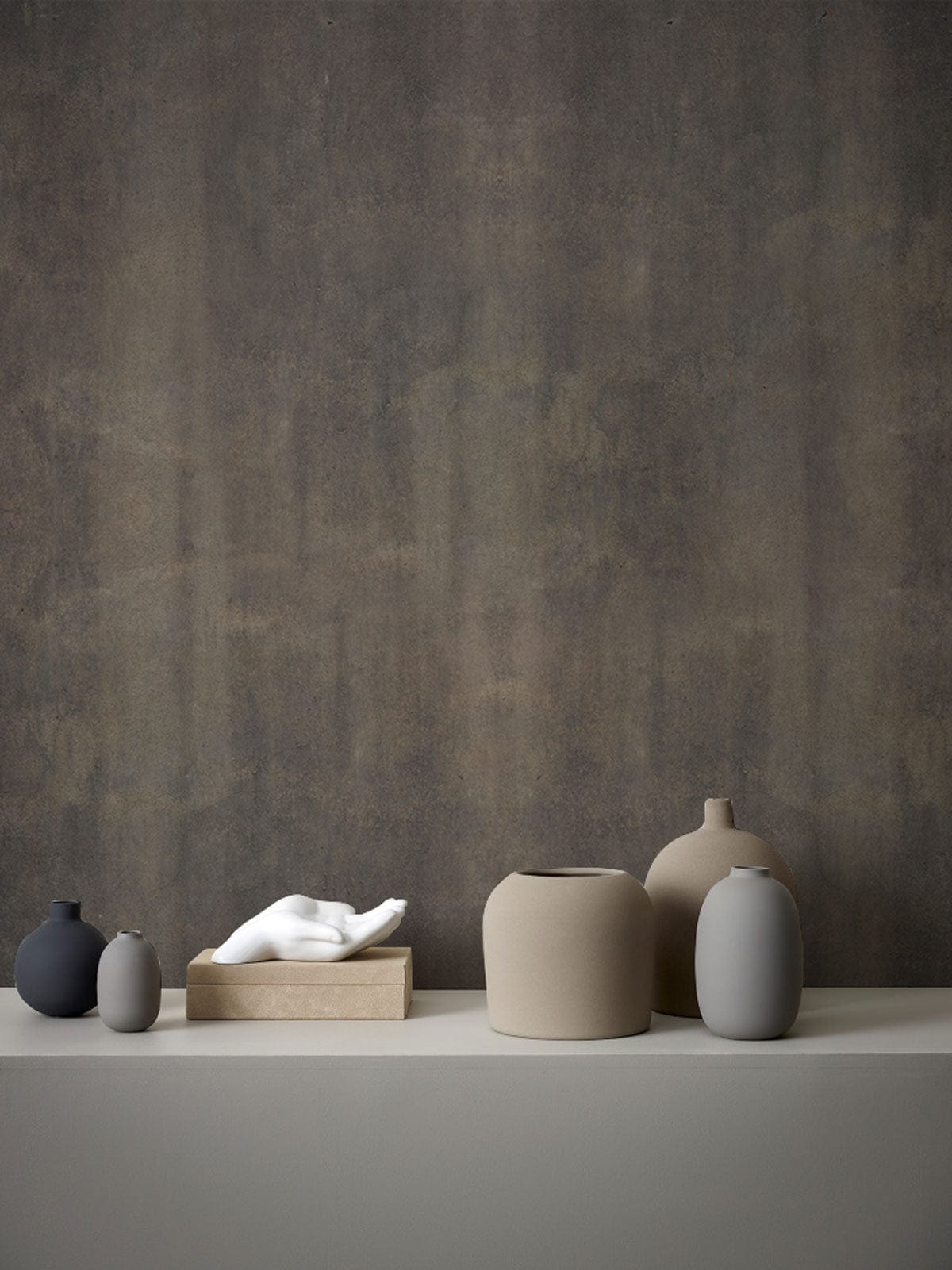 Vintage Rustic Charcoal Textured Wallpaper in industrial style, displayed with muted ceramic decor items.