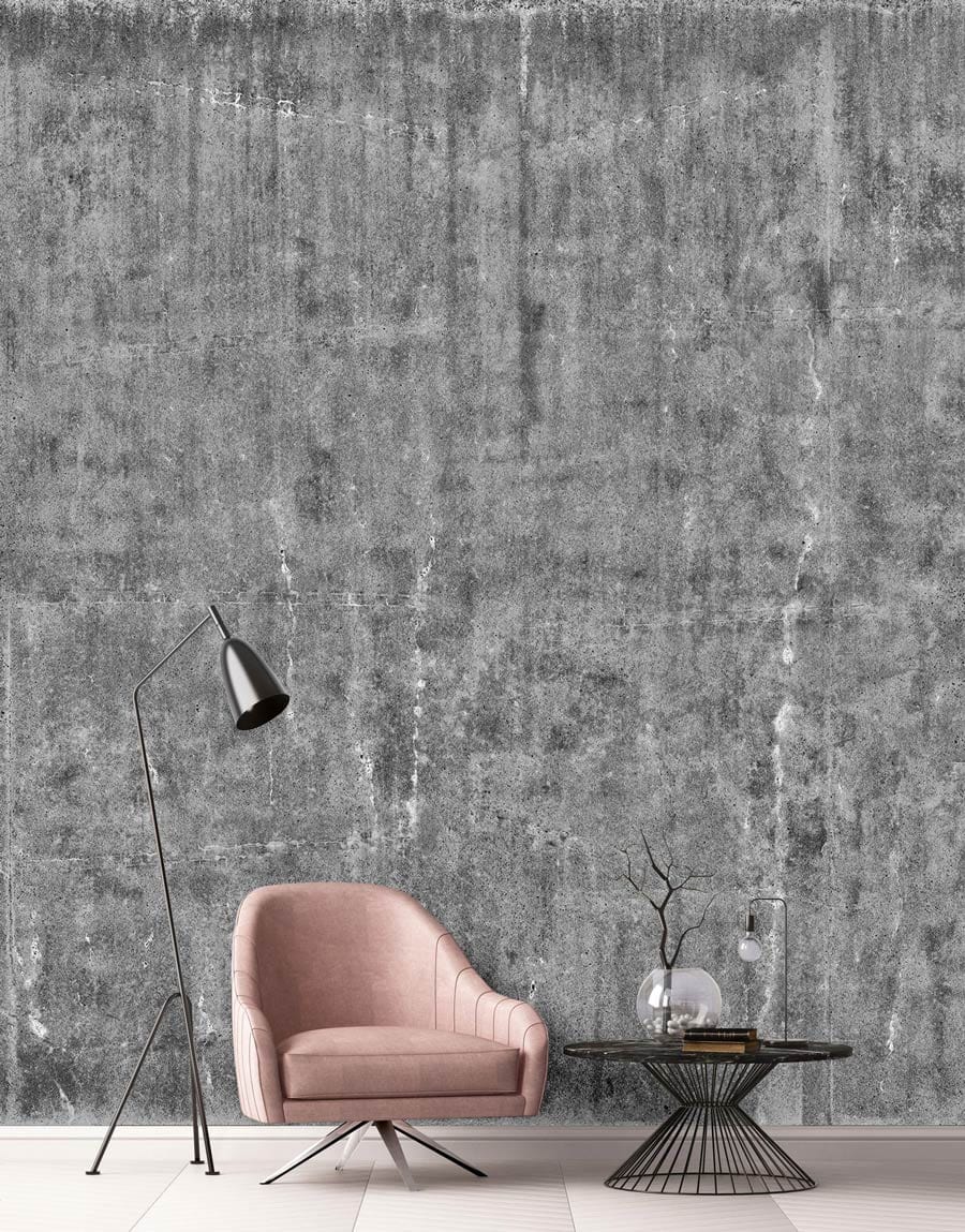 Industrial grey concrete wallpaper, pink chair, black floor lamp, wire table, modern urban decor style.