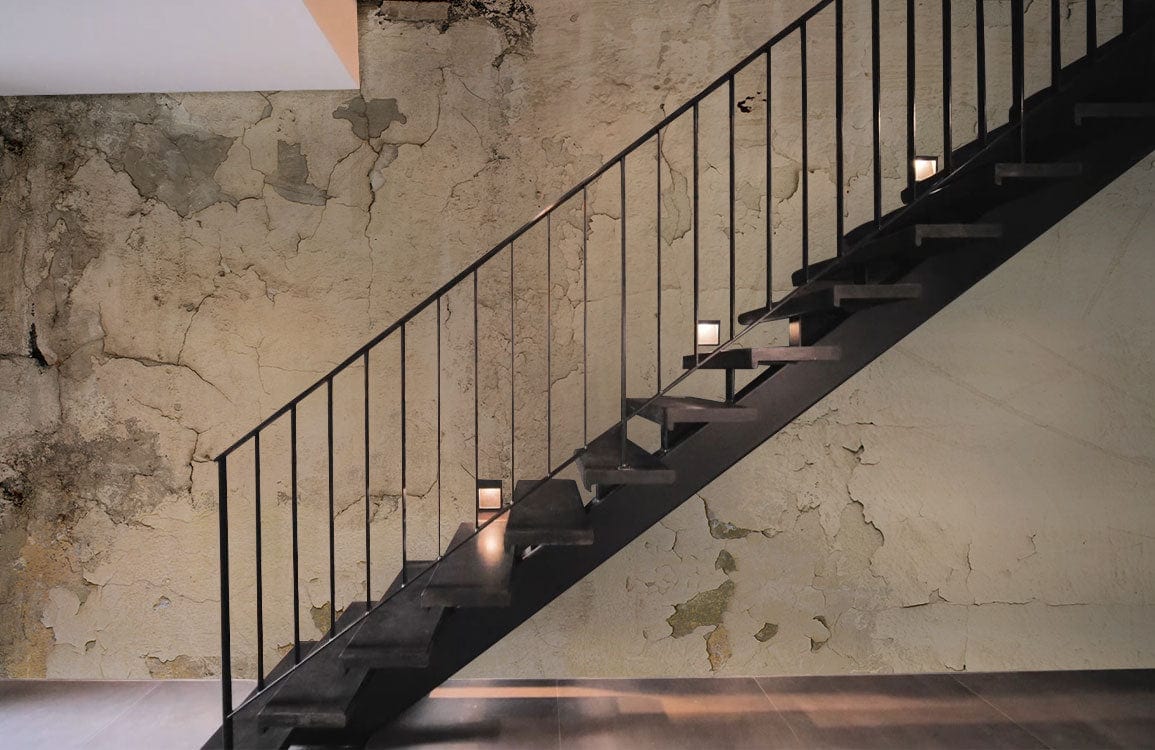 Vintage beige distressed plaster effect wall mural wallpaper with stairway, modern industrial living room design.